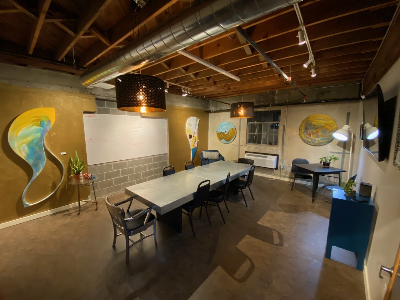Modern conference room with artistic wall murals and professional lighting
